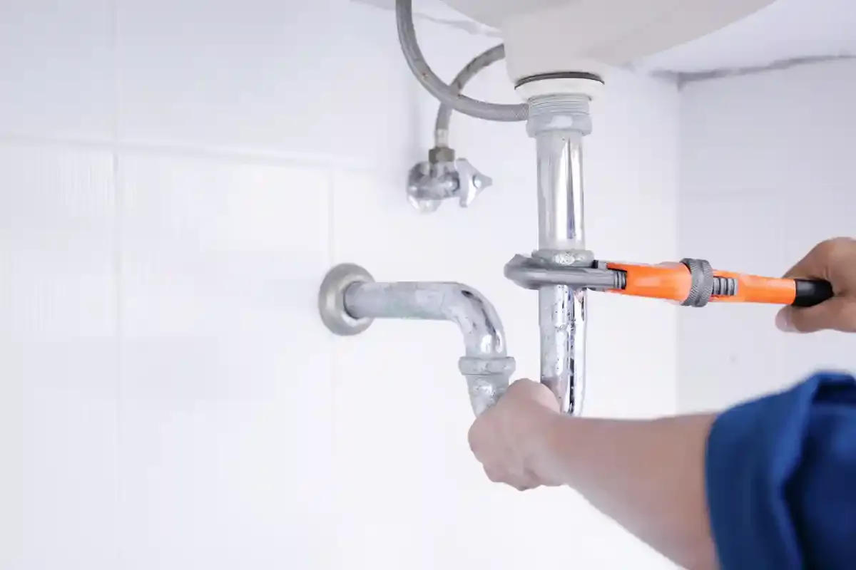 Plumber working on sink